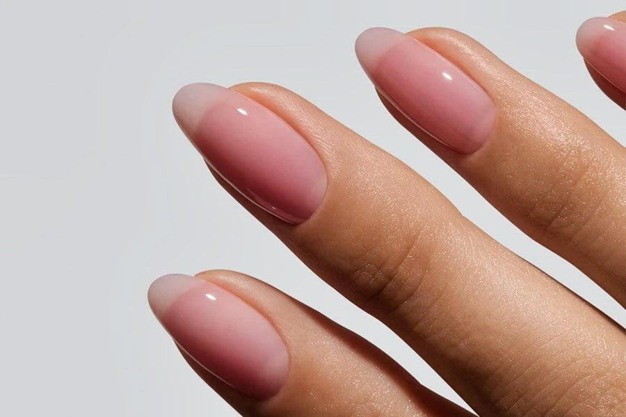 Close-up of sheer pink soap nails with glossy, freshly washed finish.