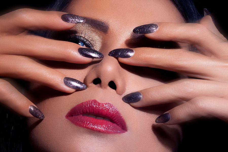 Close-up of hands with shimmering cat eye nail designs in trendy colours and patterns.